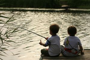 boys fishing at a cottage dock